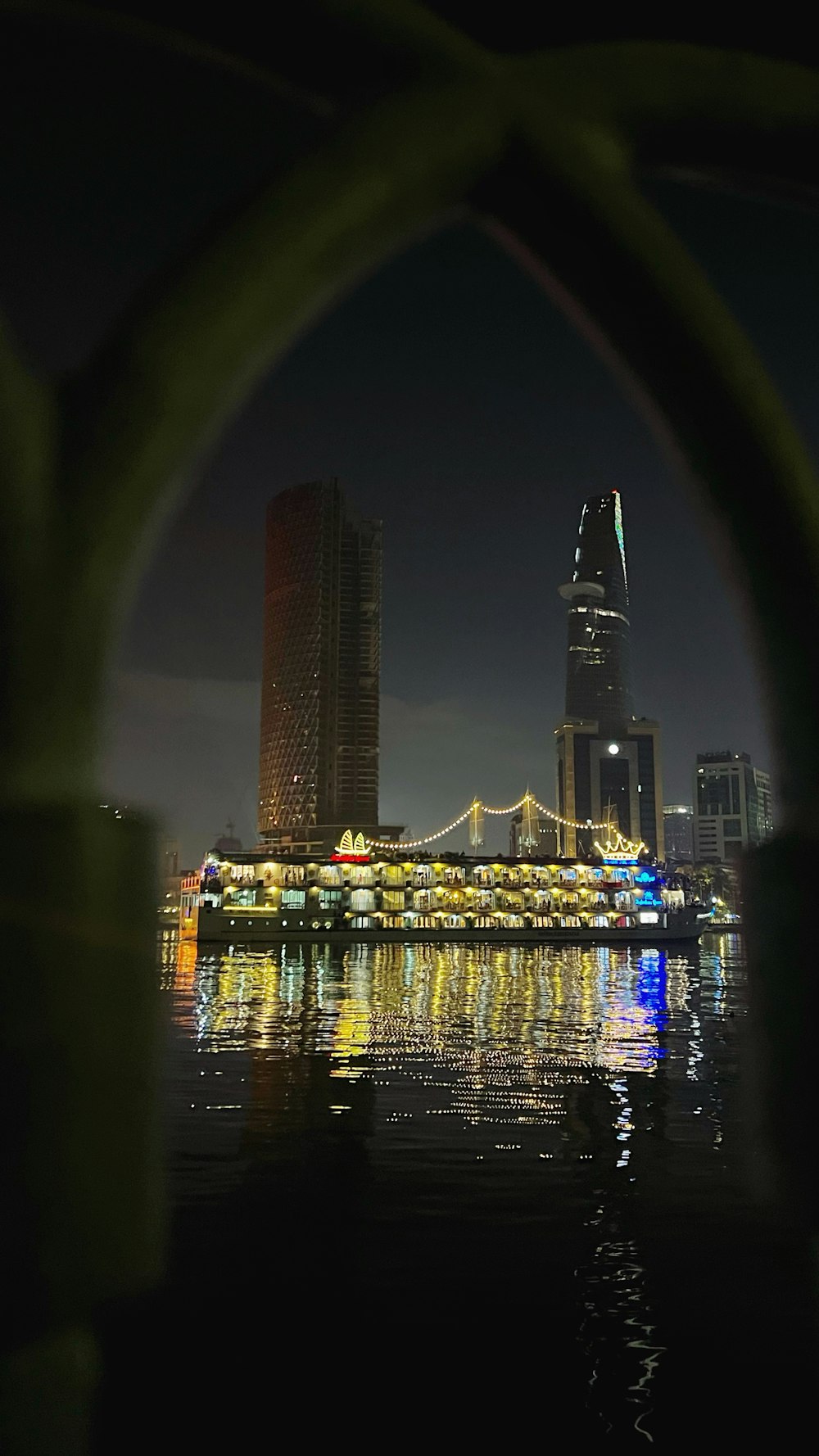 a view of a bridge over a body of water at night