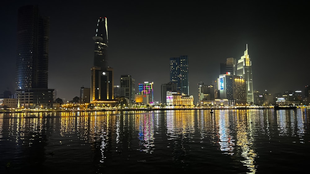 a night view of a city with lights reflecting in the water