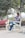 A happy man wearing casual clothing in a park.