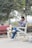A happy man wearing casual clothing in a park.