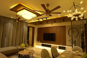 A well-lit residential living room showcasing modern lighting fixtures.