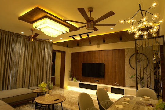 A modern living room illuminated with smart home lighting installed by Barq Al-Muttahida.