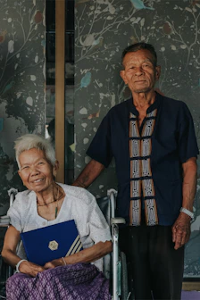 An elderly couple reviewing their retirement plan documents at home.