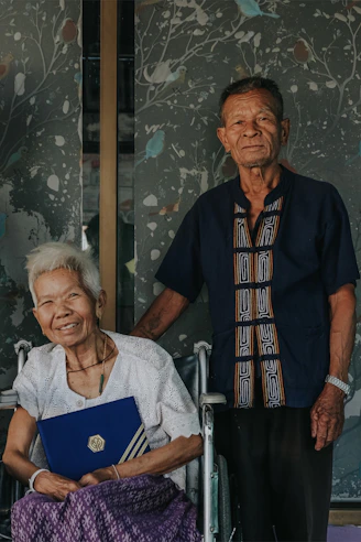 An elderly couple reviewing their retirement plan documents at home.