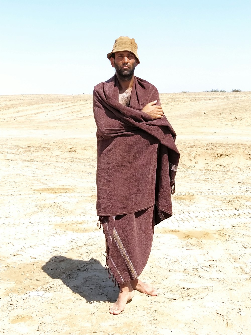 a man standing in the middle of a desert