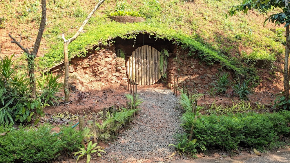 a stone building with a green roof and a wooden door