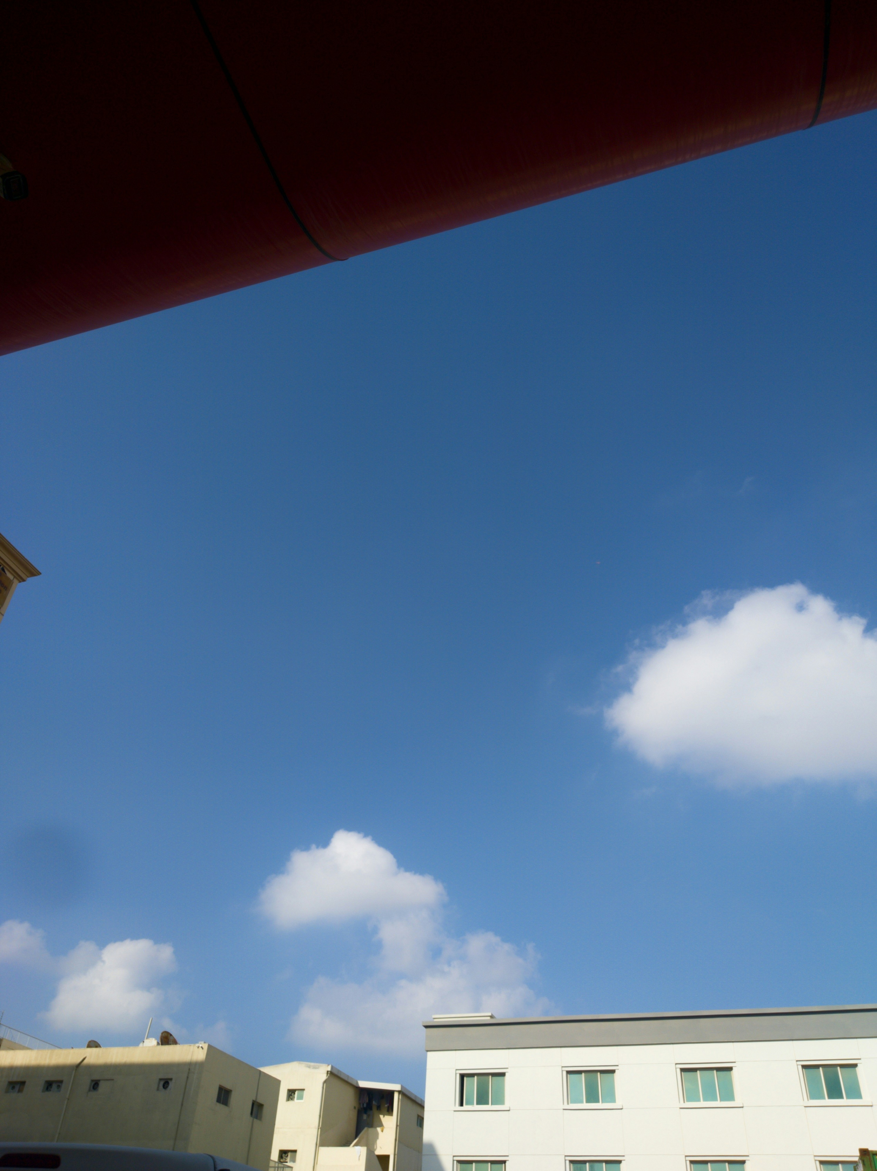 a view of a building from a parking lot