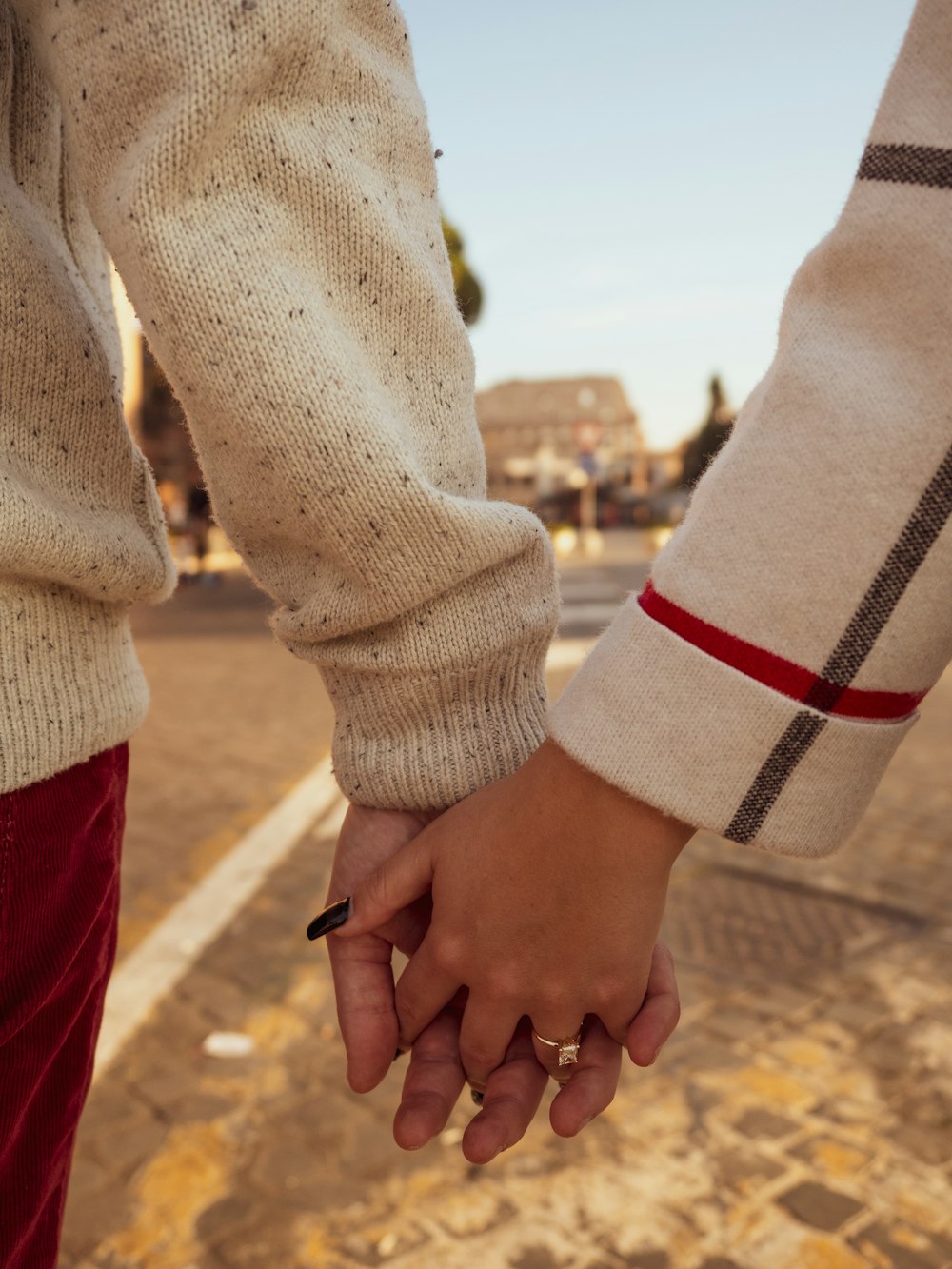 a close up of two people holding hands