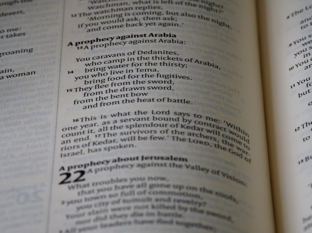 A close-up view of text from an open book, focusing on verses and prophecies from a religious script. The page numbers and chapters are visible, with some parts of the text emphasized in bold.