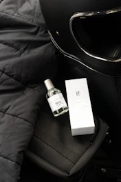 Urban commuter’s backpack and helmet next to the coffee brown Motogrit soap bar on a worn concrete ledge.