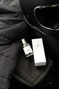 Urban commuter’s backpack and helmet next to the coffee brown Motogrit soap bar on a worn concrete ledge.