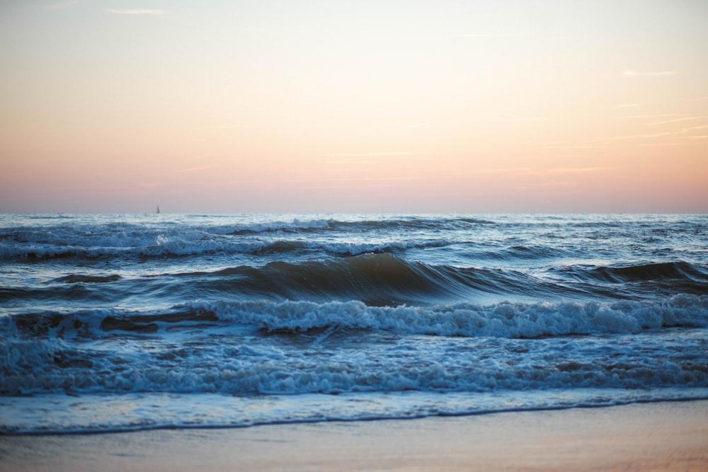 a view of the ocean at sunset from the beach