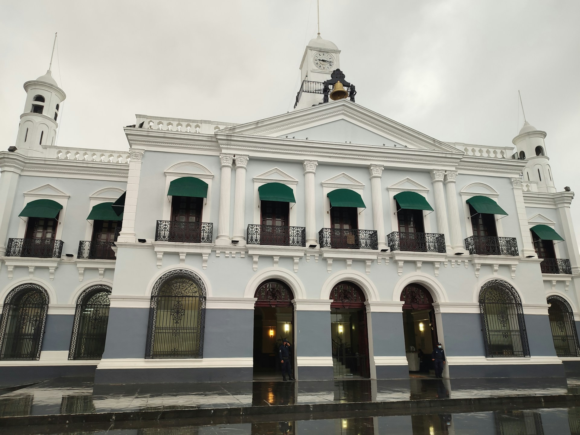 a large white building with a clock tower on top of it