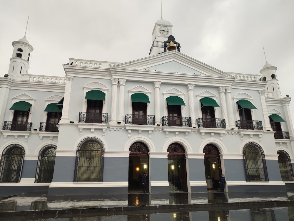 a large white building with a clock tower on top of it