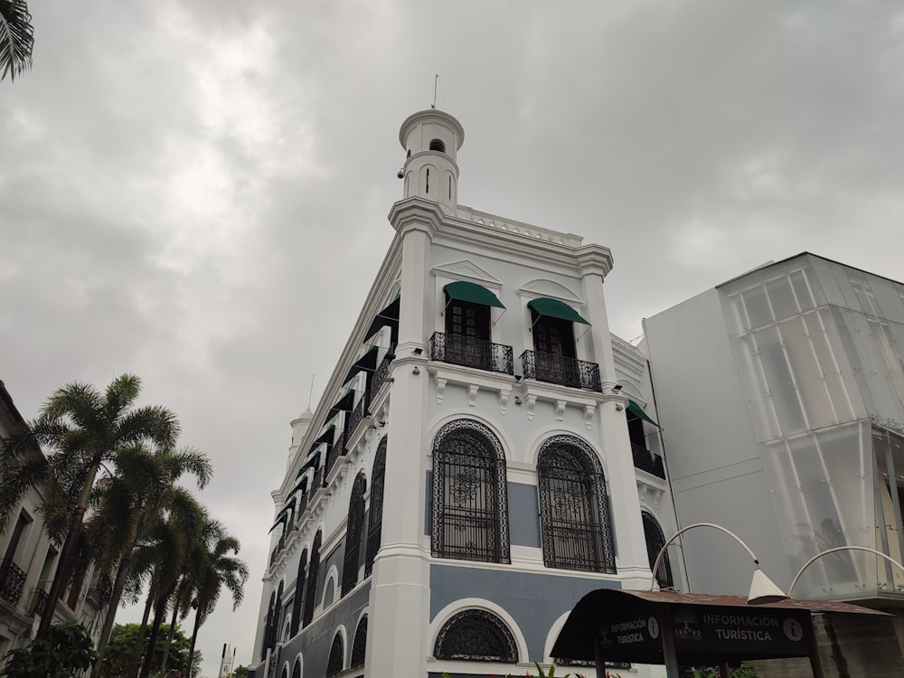 a white and blue building with a clock tower