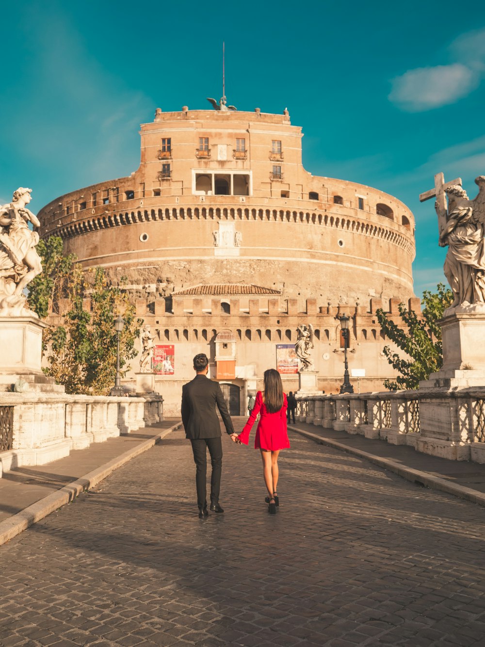 a man and a woman walking in front of a building