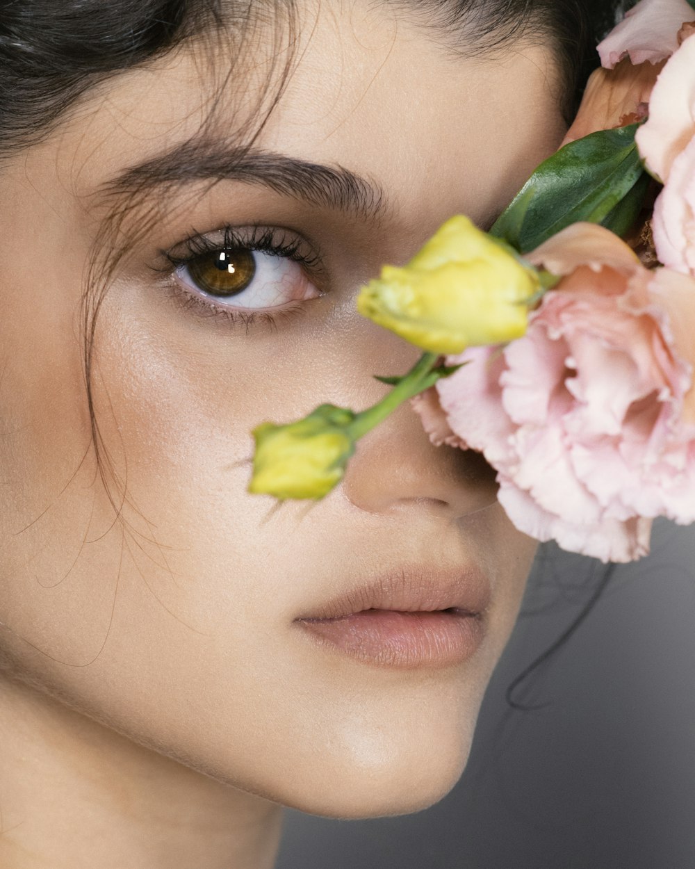 a close up of a person with flowers in their eyes