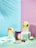 A vibrant assortment of colorful detox juices in clear glasses.