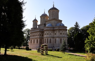 A historic building with beautiful architecture and greenery.