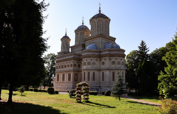 A historic building with beautiful architecture and greenery.