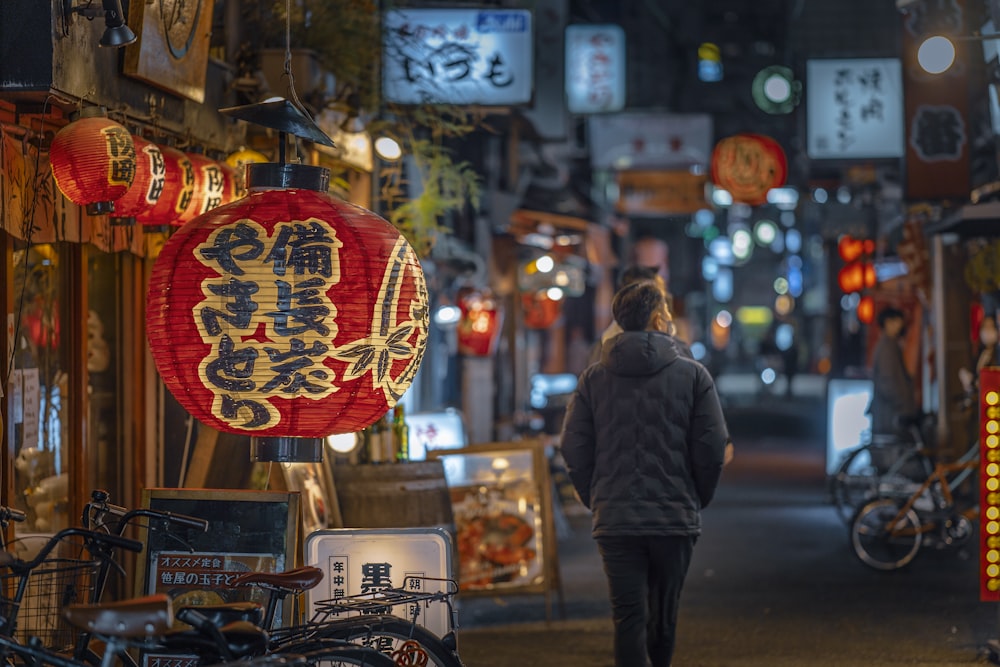 a woman walking down a street at night