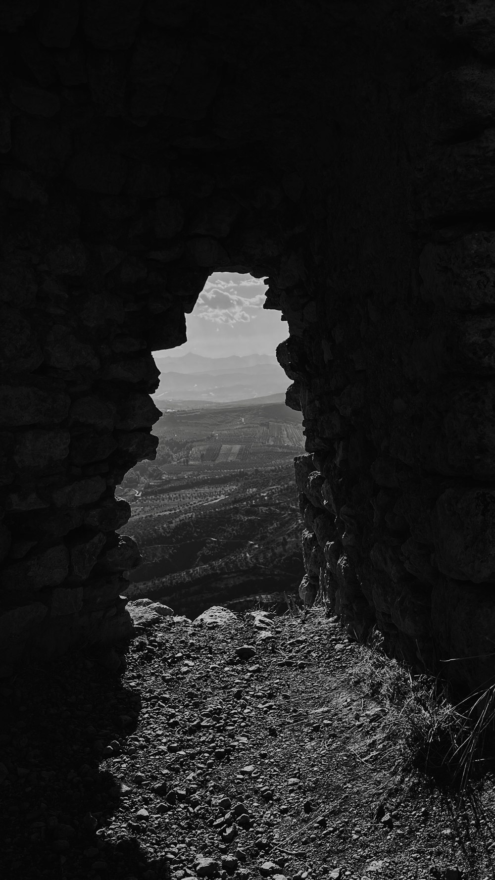 a black and white photo of a stone wall