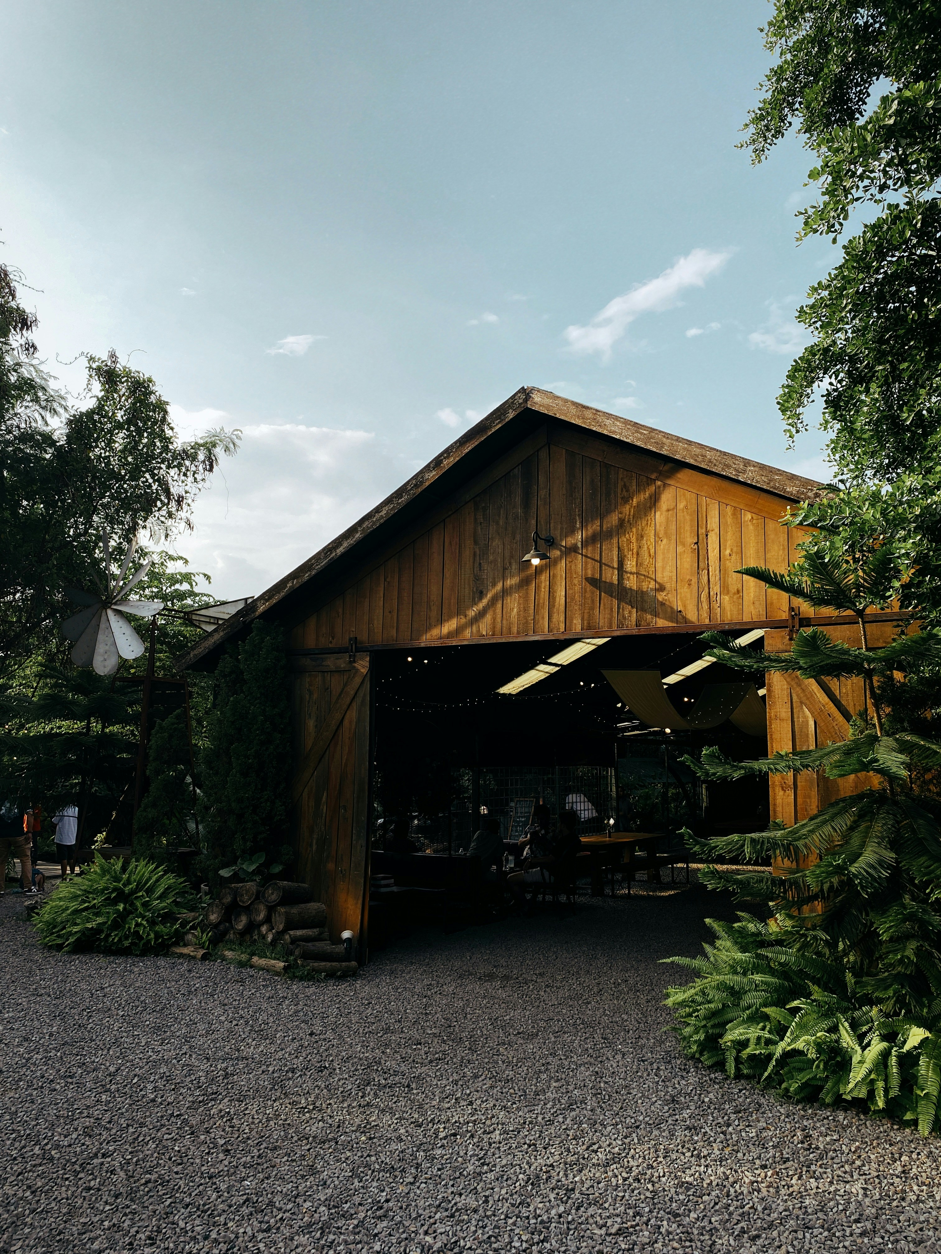 a large wooden building sitting next to a lush green forest