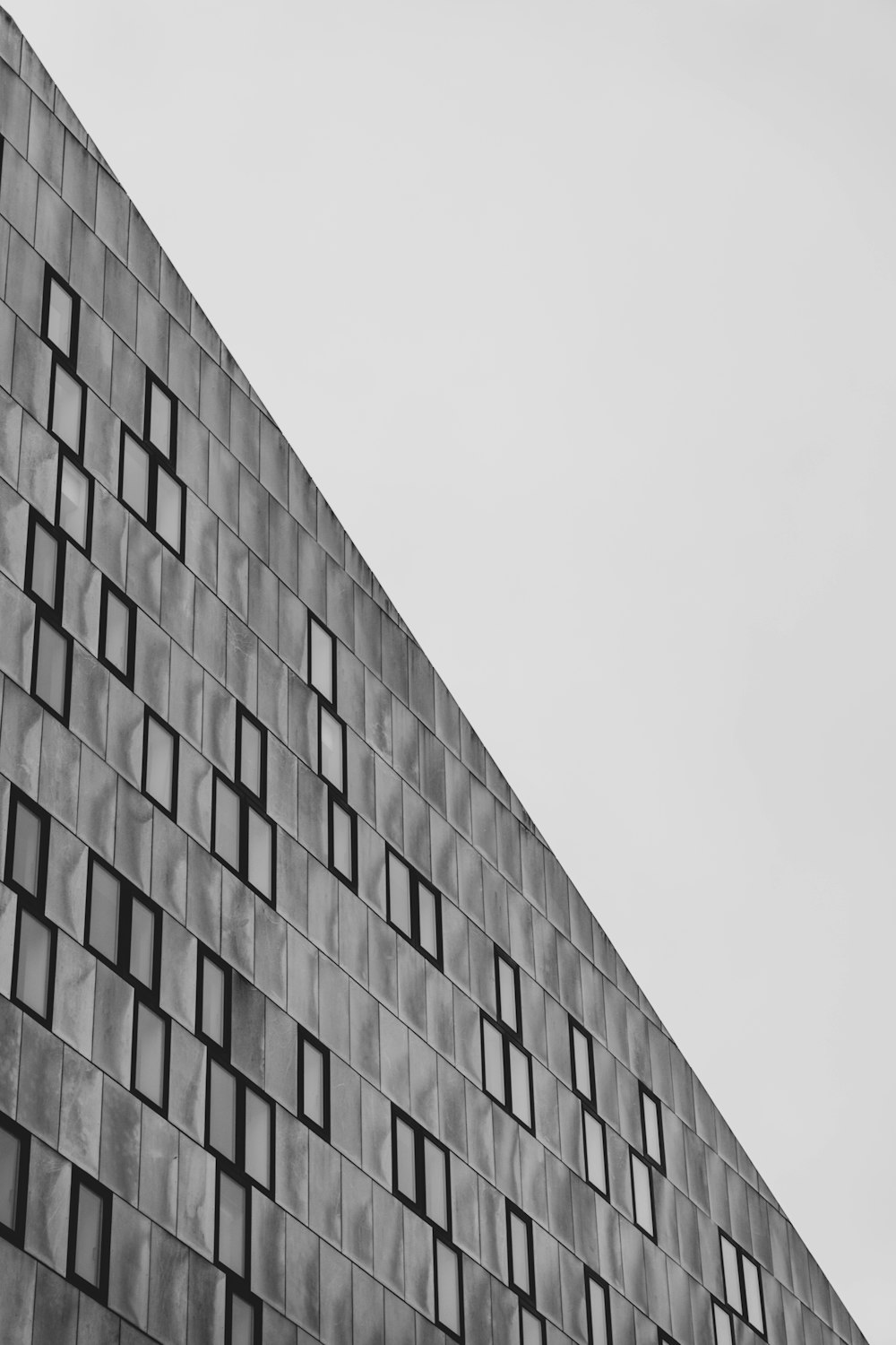 a black and white photo of a building with many windows