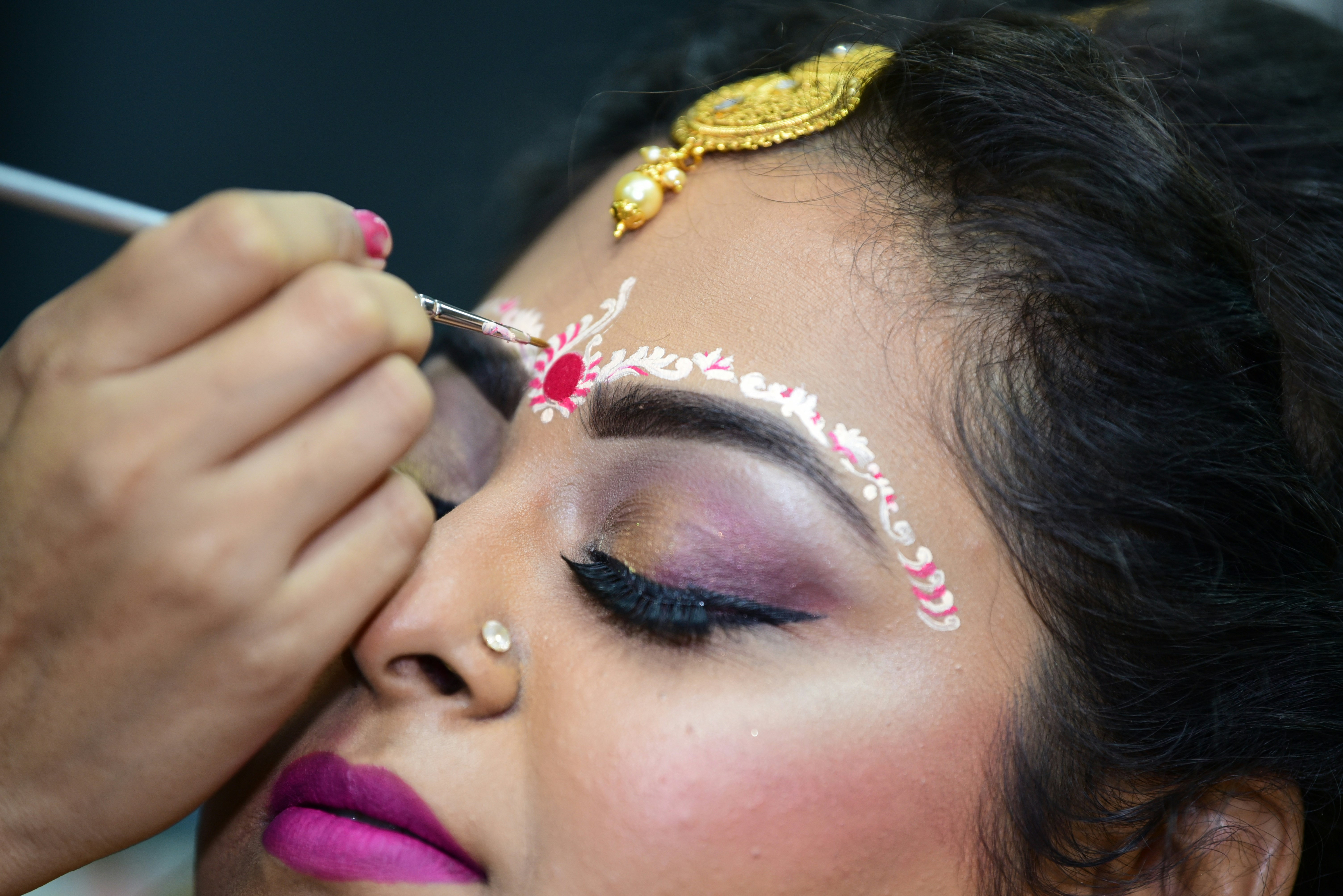 a woman is getting her make up done