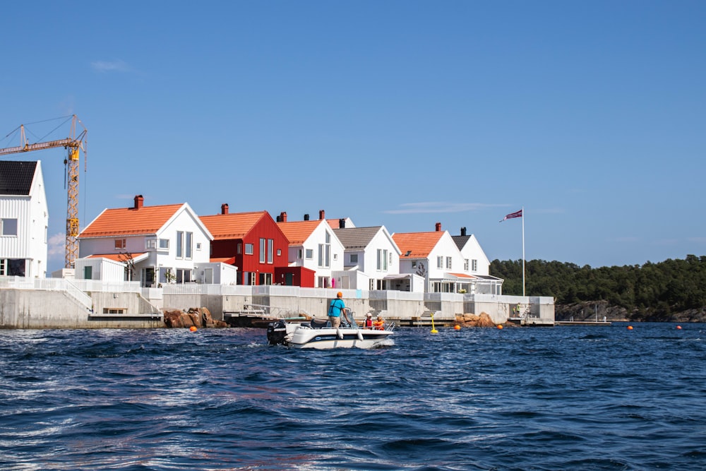 a row of houses sitting on top of a body of water