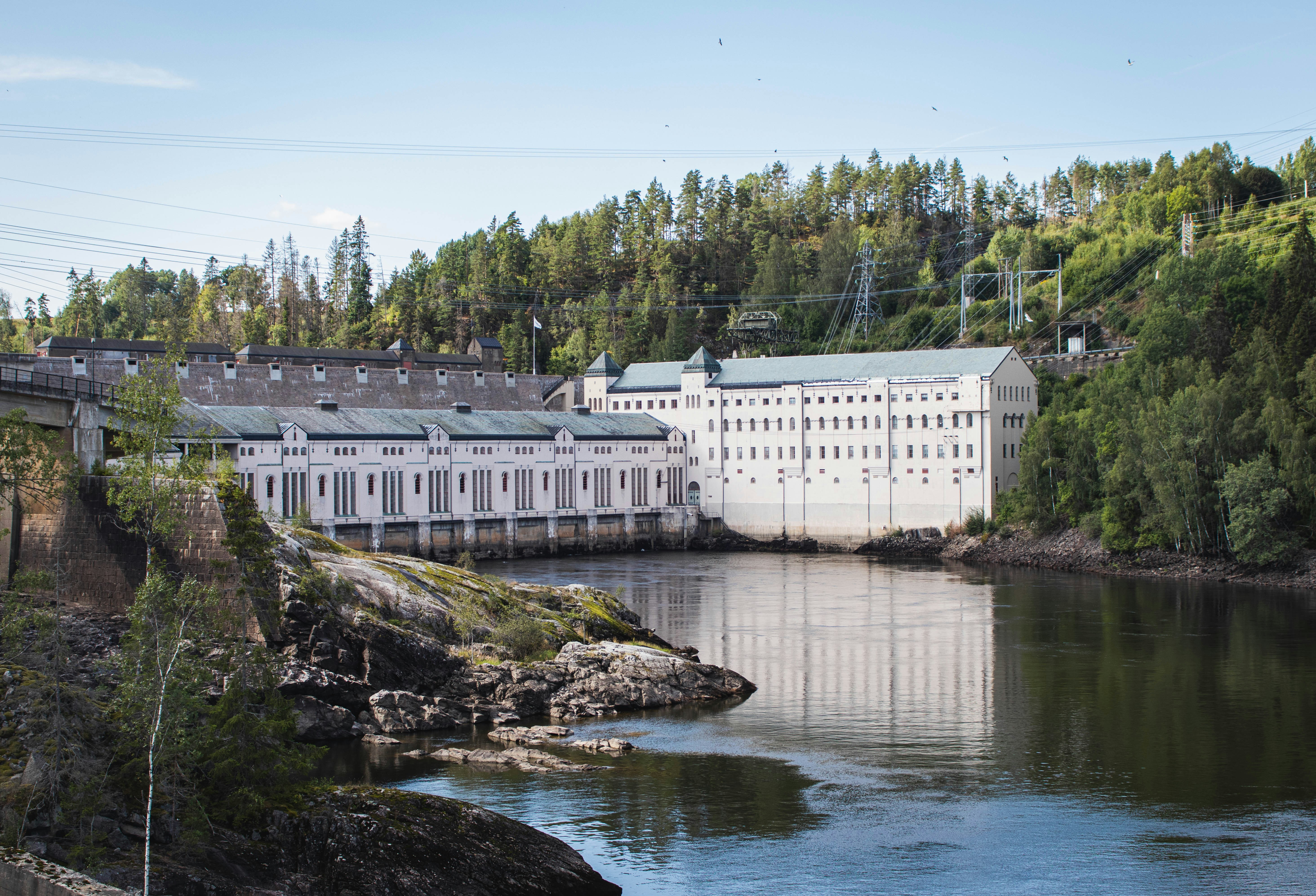 a large white building sitting on the side of a river