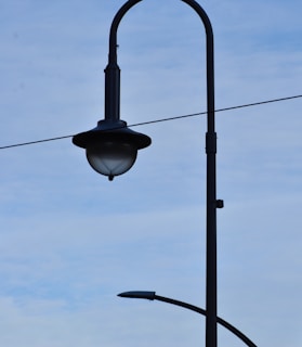 a street light on a pole with a blue sky in the background