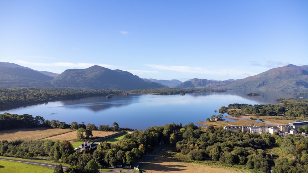 an aerial view of a lake surrounded by mountains