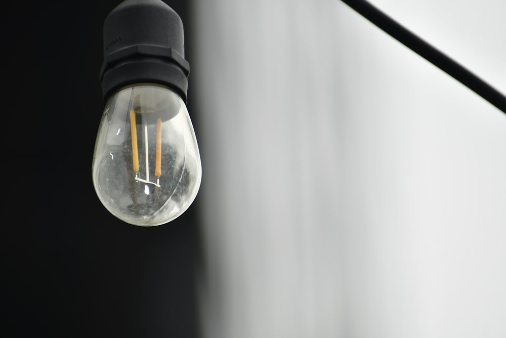 a light bulb hanging from the side of a wall