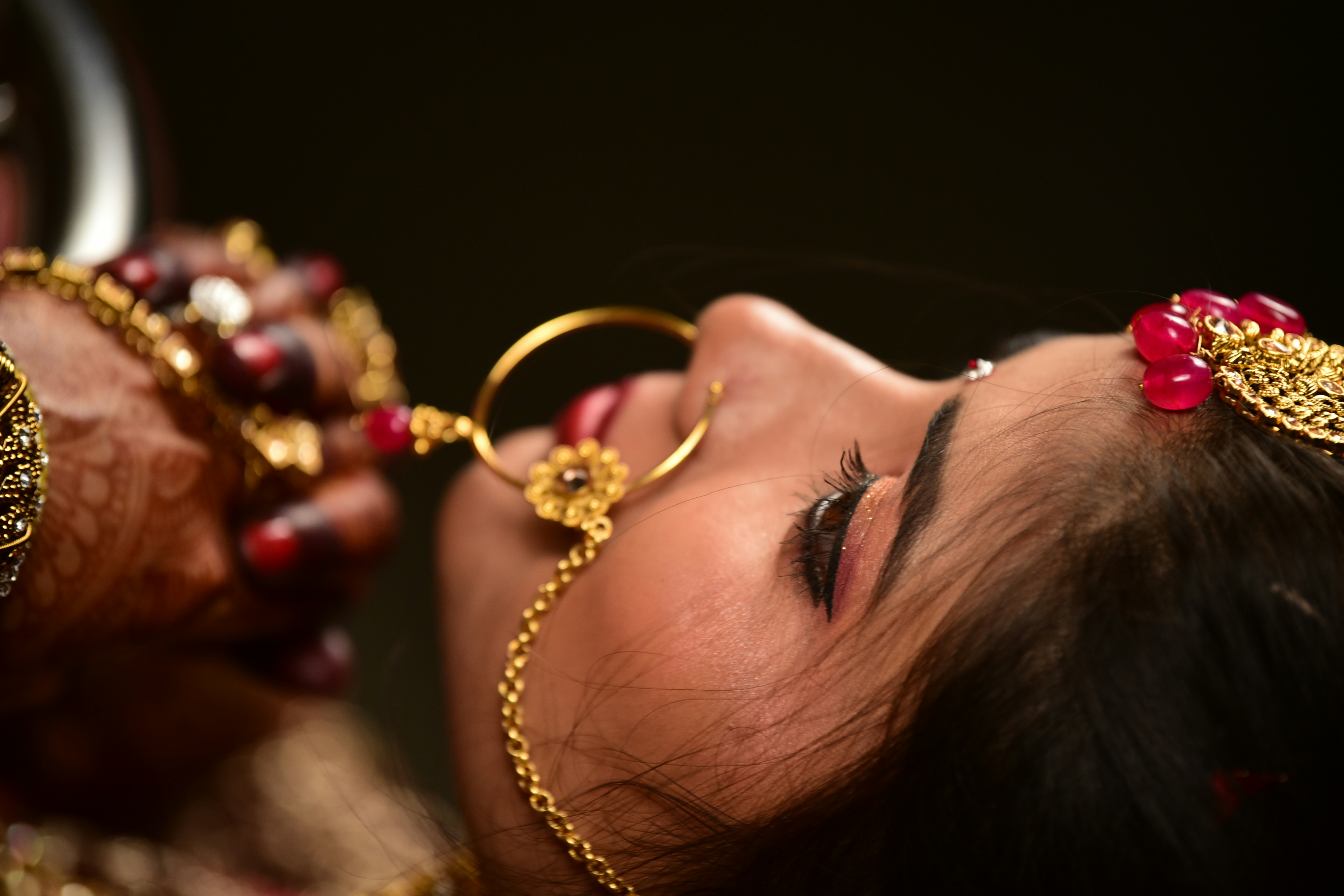 A glamorous photo of an actress (representative of Ranya Rao), looking thoughtful or serious, juxtaposed with a blurred image of gold bars or coins.