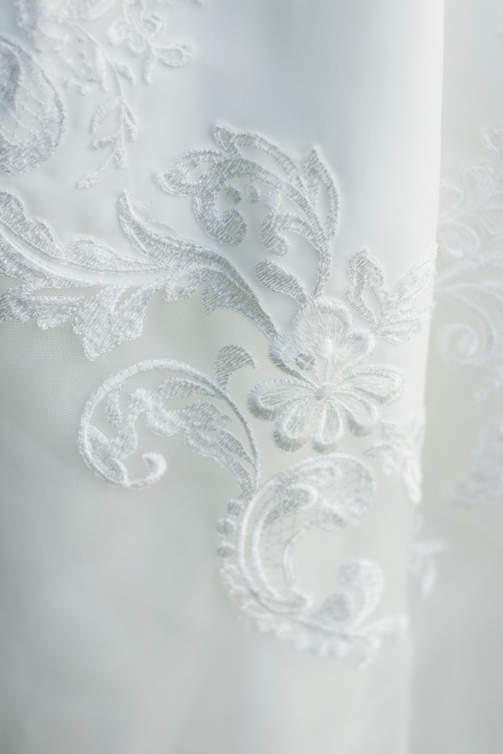 a close up of a white wedding dress