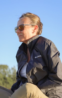 a woman sitting on the back of a horse