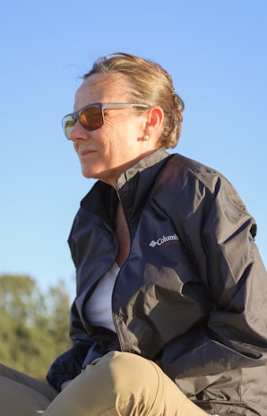 a woman sitting on the back of a horse