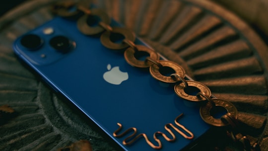 Stylish iPhone with a unique chain-decorated fashion cover in deep blue.