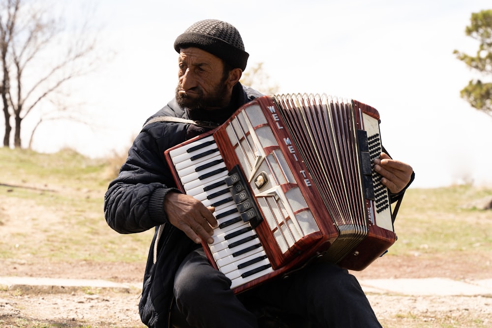 a man playing an accordion in a field