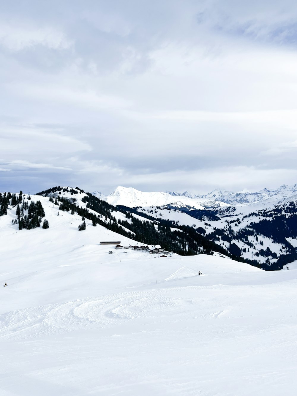 a man riding skis on top of a snow covered slope