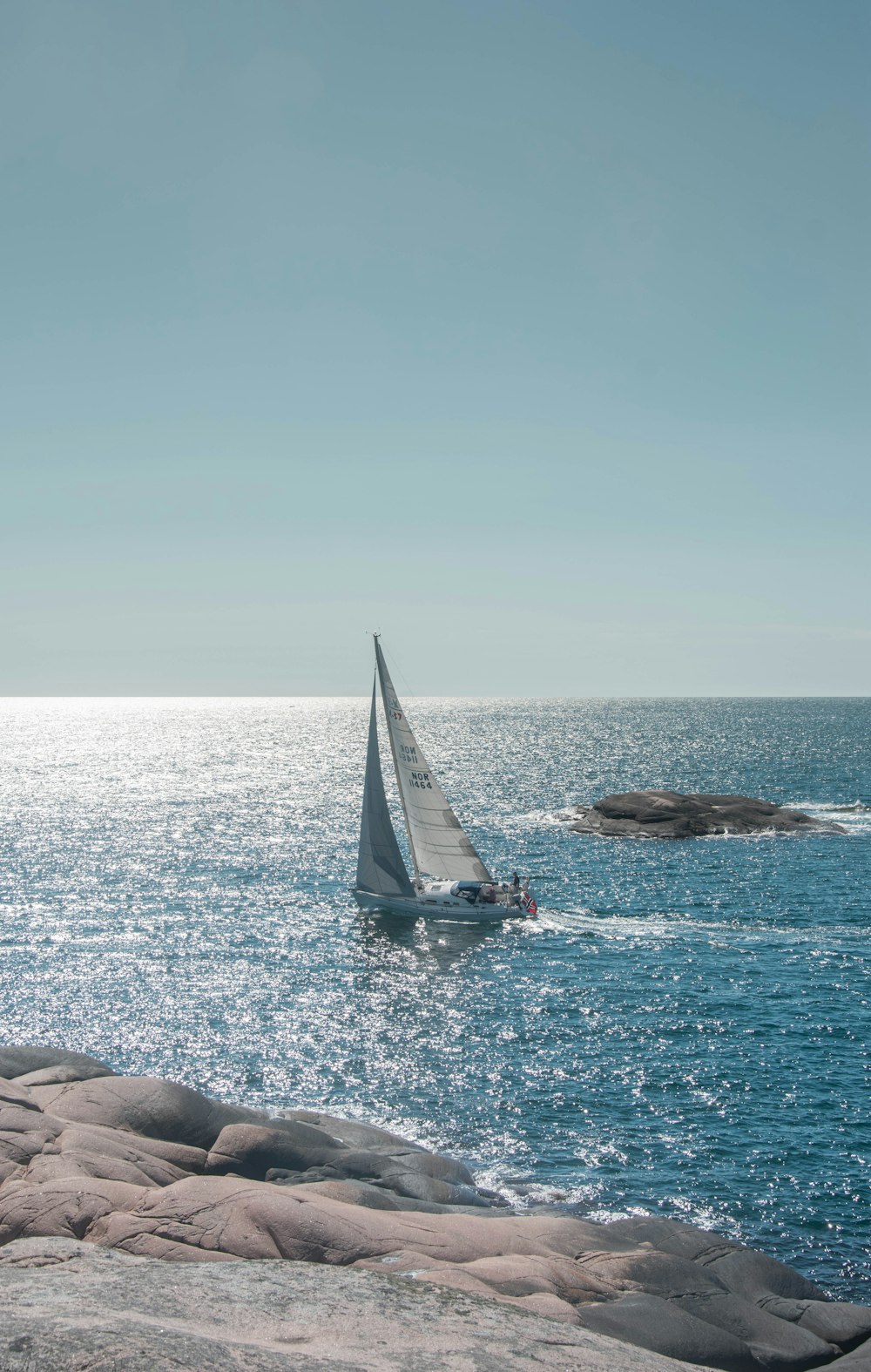 a sailboat in the middle of the ocean