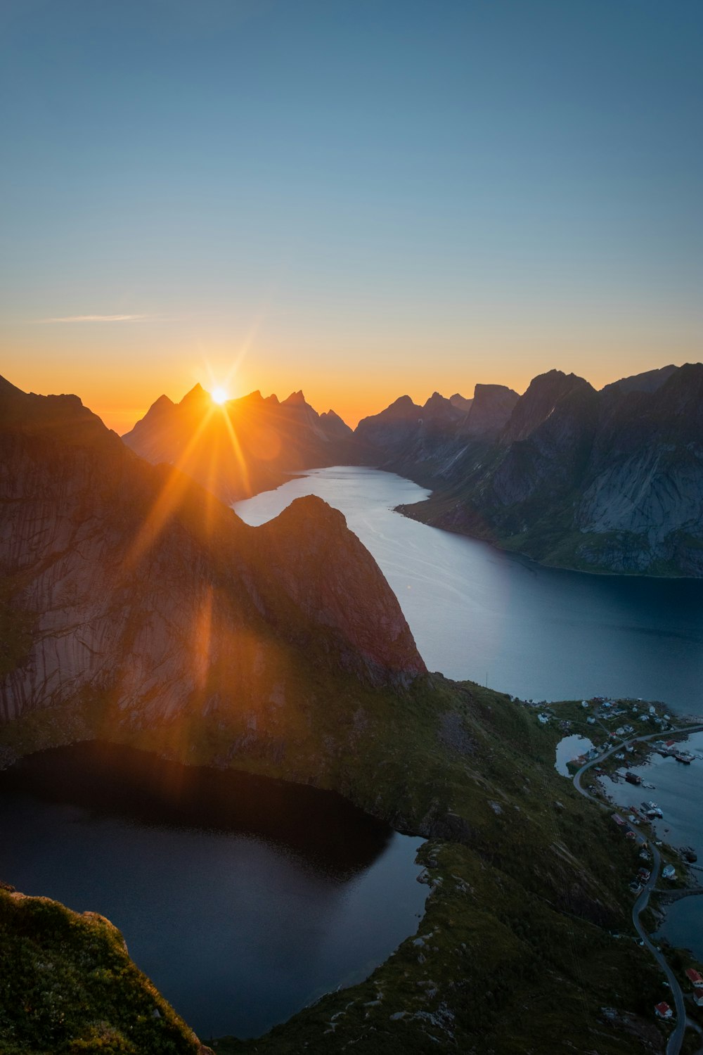 the sun is setting over a mountain range