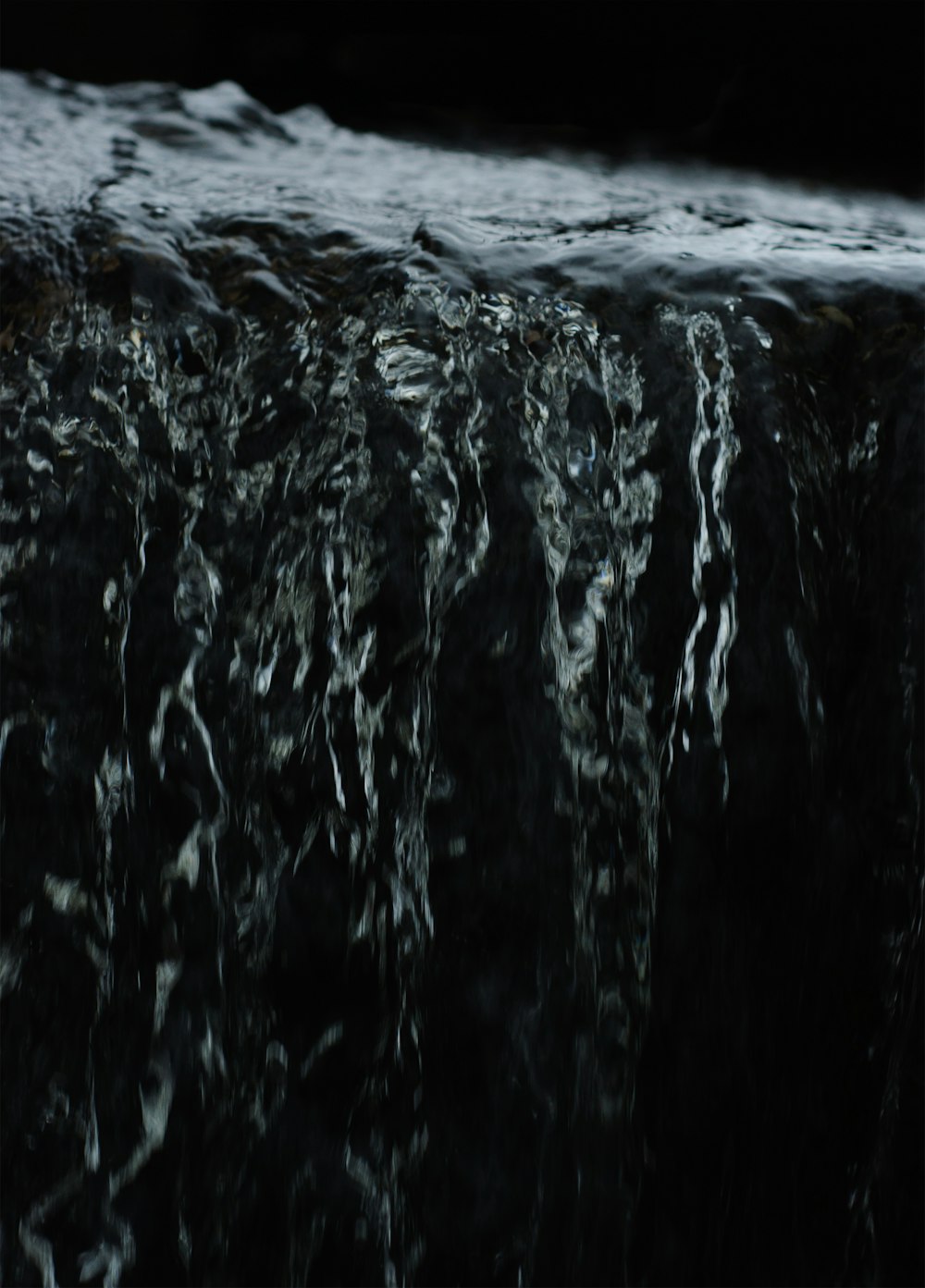 a close up of a waterfall in the water