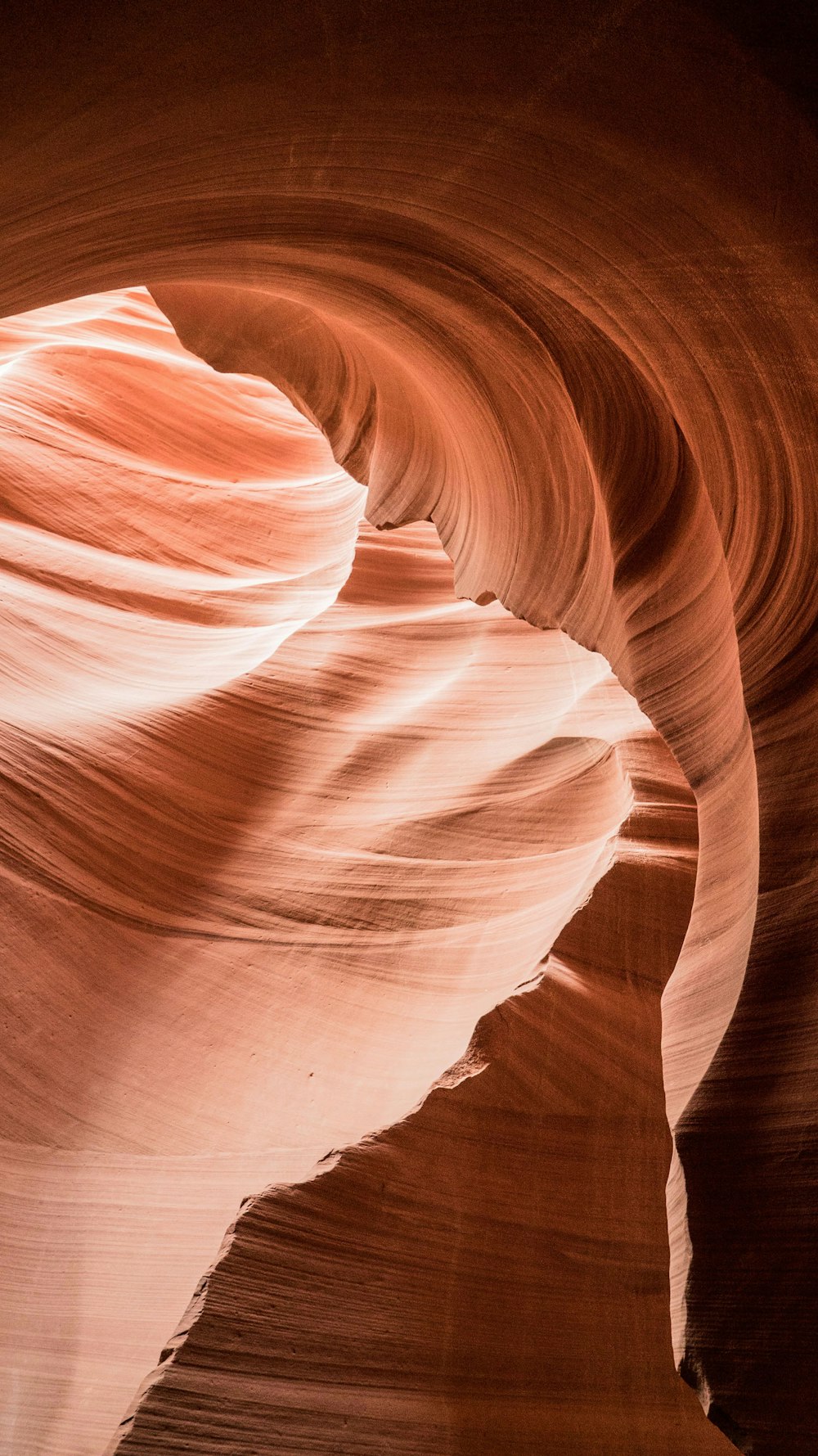 a person standing in a slot in a canyon