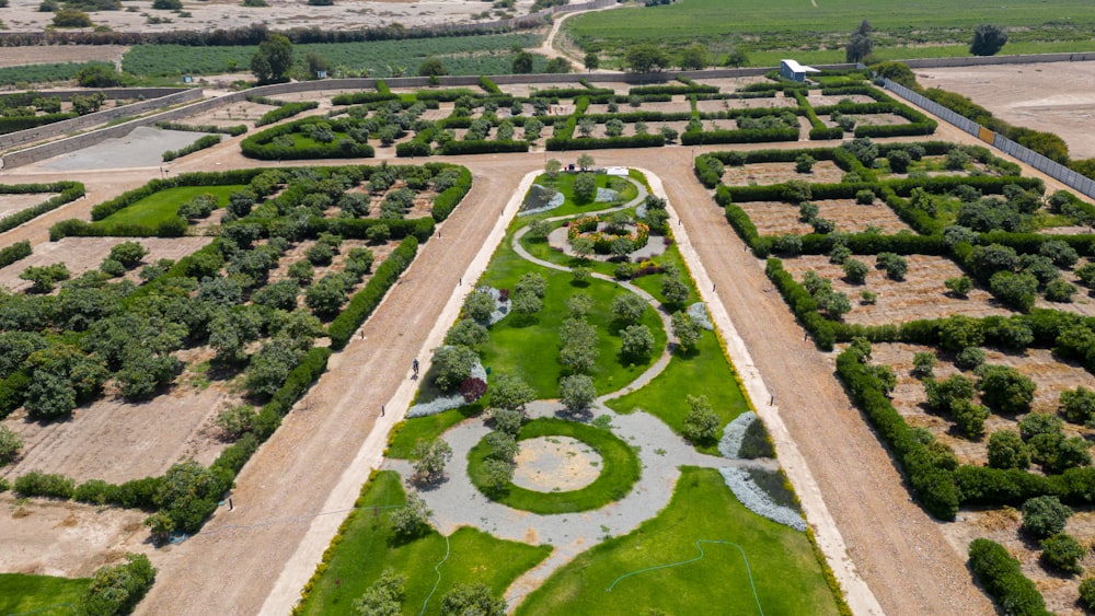 an aerial view of a garden in the middle of a field