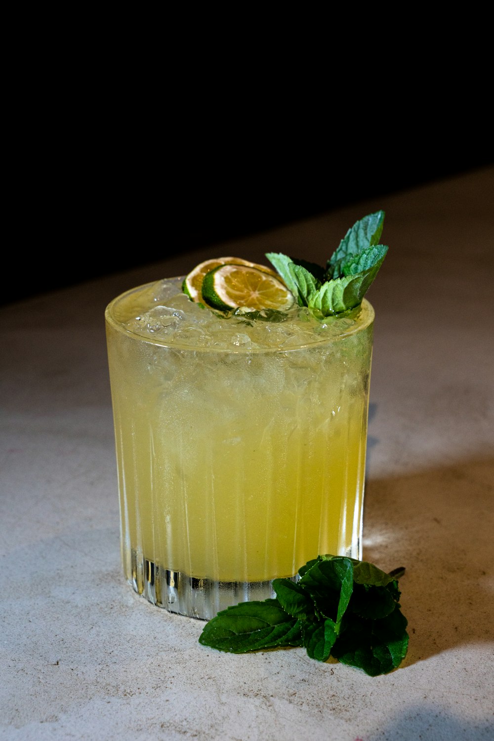 a glass of lemonade with a mint garnish
