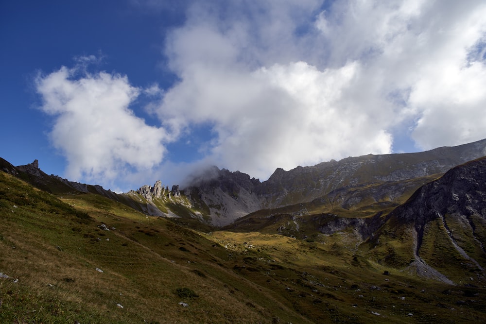 a view of a mountain range with clouds in the sky