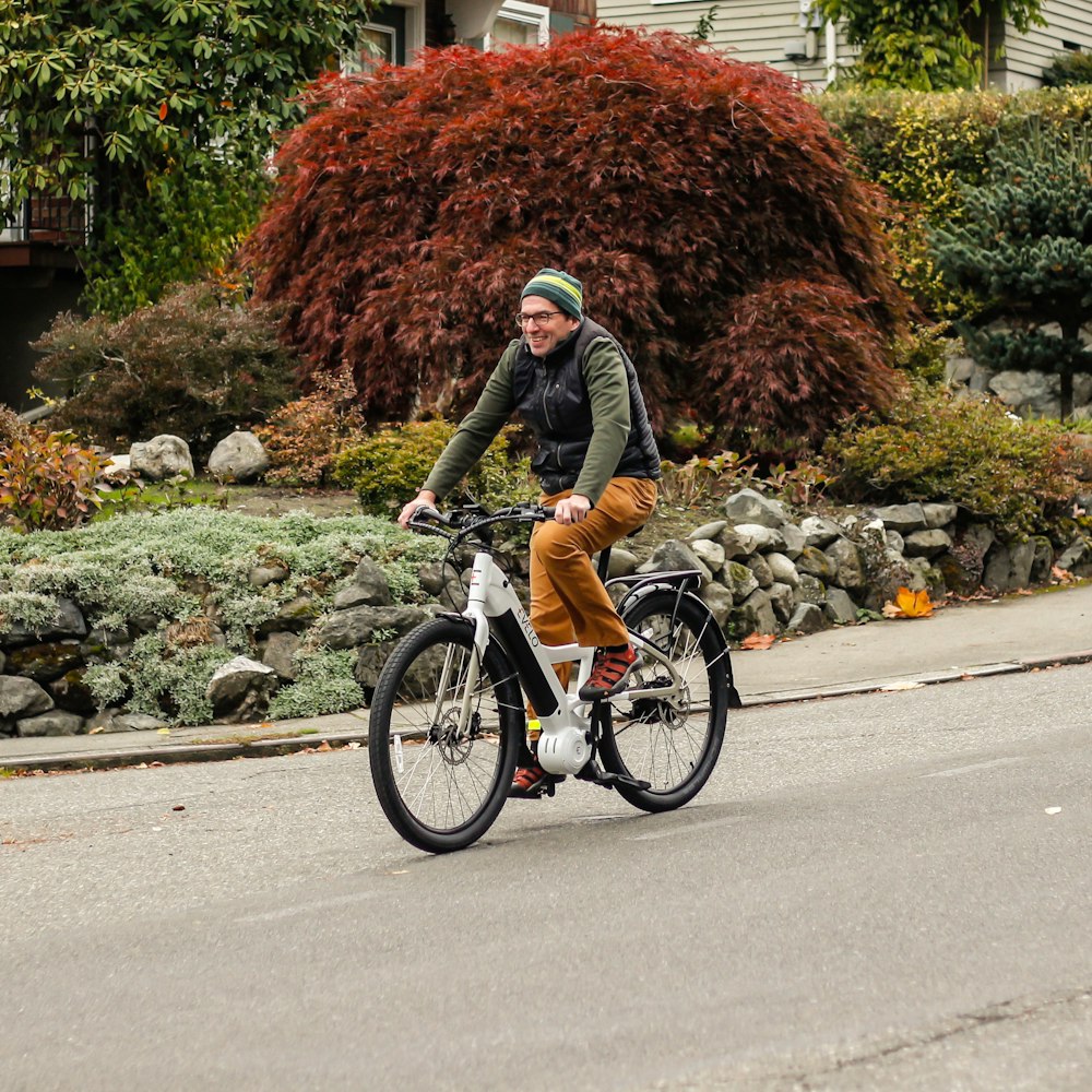 a man riding a bike down a street