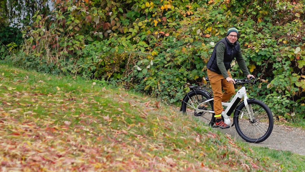 a man riding a bike down a dirt road